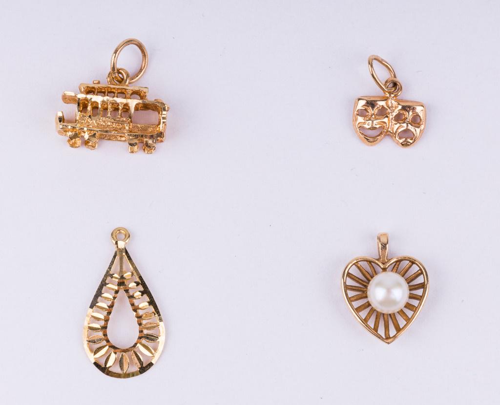 14K Gold Pendants (4): Lot includes four 14K gold pendants including trolley car, heart with pearl, theater masks and a tear drop shape. Tear drop pendant is the longest, measuring approx 3/4" L. Total weight approx 2.8 dwt