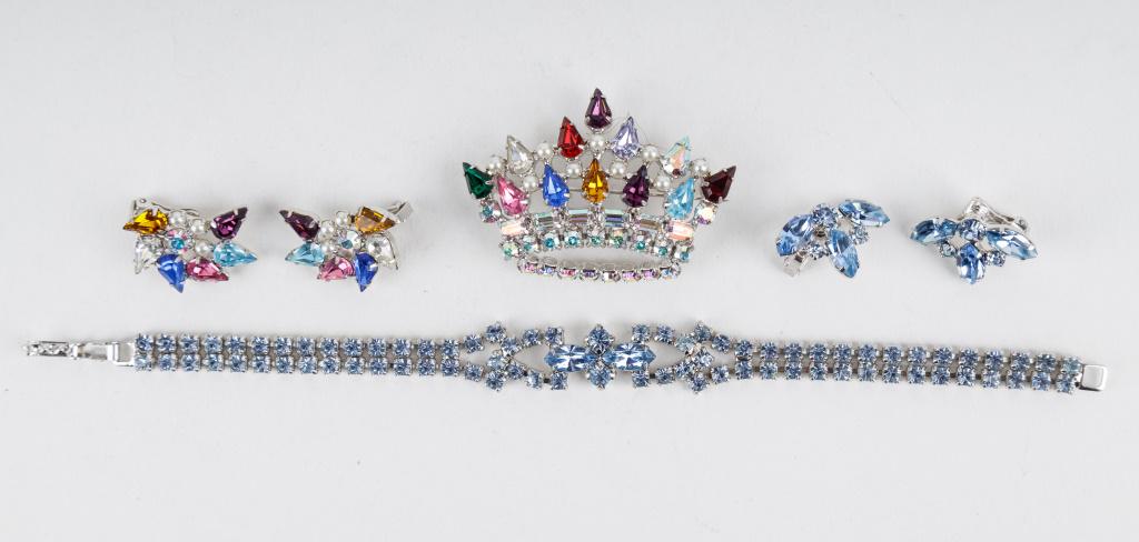 Vintage Costume Jewelry Sets: Two vintage silver tone rhinestone jewelry sets including a blue rhinestone bracelet and clip earring set as well as B. David brooch and clip earring set with colorful rhinestones.