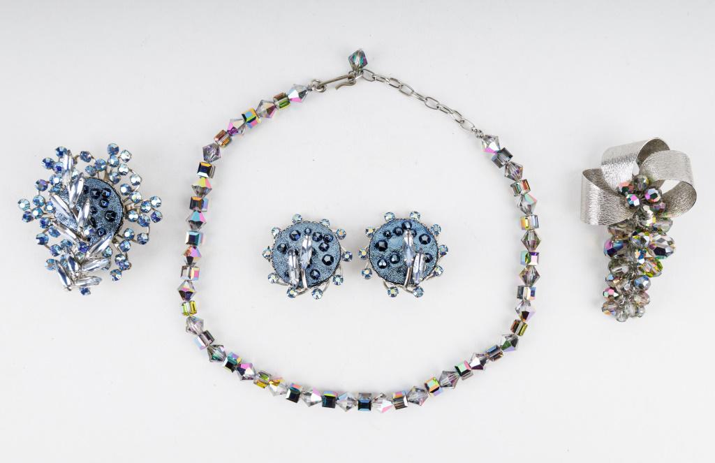 Vintage Costume Jewelry Sets: Two costume jewelry sets including a rainbow rhinestone necklace and brooch set (necklace approx 15" L) as well as a blue rhinestone Judy Lee brooch and earring set.