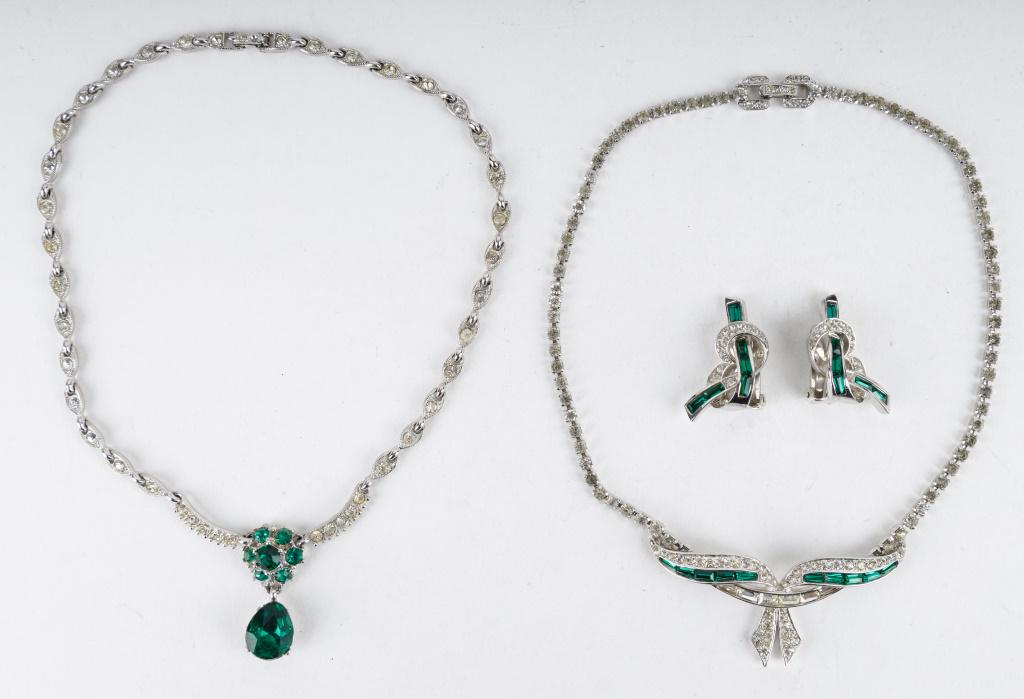 Vintage Costume Jewelry: Lot includes a Boucher silver tone and rhinestone necklace and clip earring set with bow design as well as another green and white rhinestone costume necklace.