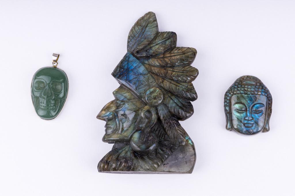 Jade Buddha Pendant & Labradorite Figures: Carved jade pendant and carved labradorite figurine. Laboradorite Native American figurine measures approx 4.25" H and weighs approx 6.5oz.. Laboradorite Buddha head pendant weighs approx 0.98oz.. Jad