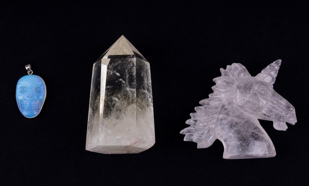 Moonstone and Rock Crystal: Moonstone skull pendant, rock crystal carved unicorn and a quartz crystal obelisk with phantoms (approx 3.5" H x 2" dia).