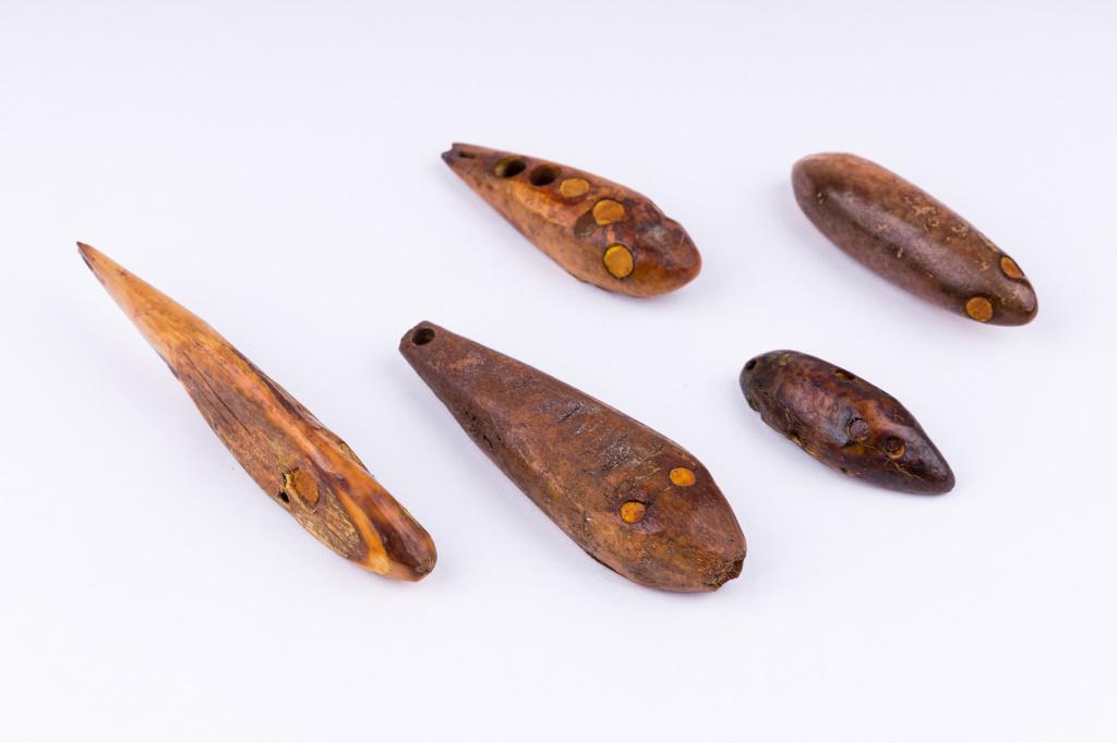Antique Inuit Fishing Lures: Antique Inuit inupiaq (Inupiak) artifacts from Savoonga, Wales & Koyuk, Alaska. Lot consists of three carved walrus fishing lures. Largest measures approx 3" L. All three have inset eyes and estimated