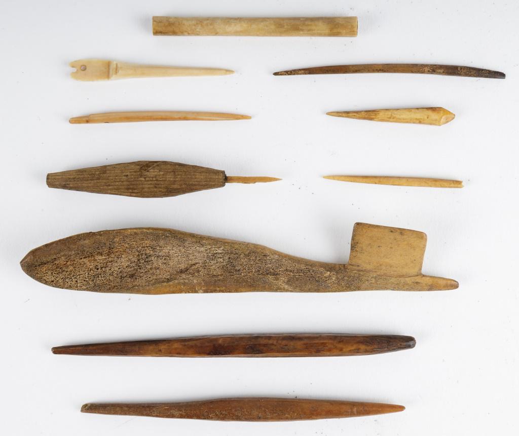 Antique Inuit Tattooing & Net Making Tools: Antique Inuit inupiaq (Inupiak) artifacts from Savoonga, Wales & Koyuk, Alaska. Lot includes a wood handled tattoo needle with walrus bone tattoo needle, net gauge, 4 bone awls, 3 bone needles and one