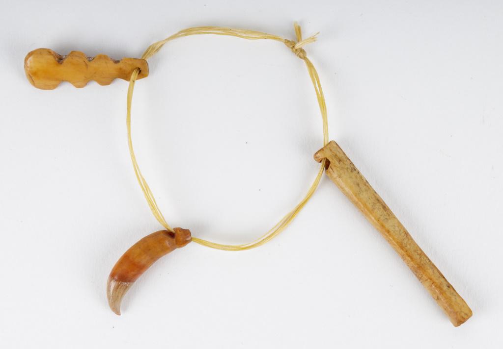 Vintage Inuit Pendants & Whistle: Antique Inuit inupiaq (Inupiak) artifacts from Savoonga, Wales & Koyuk, Alaska. Two animal tooth pendants and a whistle. Whistle measures approx 2.25." L.