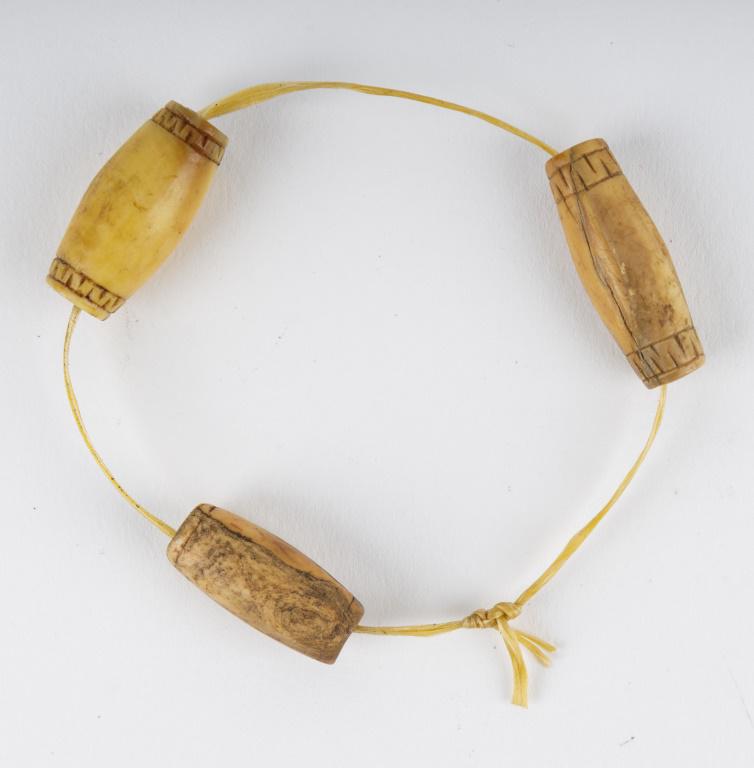Antique Inuit Carved Walrus Beads: Antique Inuit inupiaq (Inupiak) artifacts from Savoonga, Wales & Koyuk, Alaska. There are 3 antique inuit carved walrus beads, which average approx 1" L each.