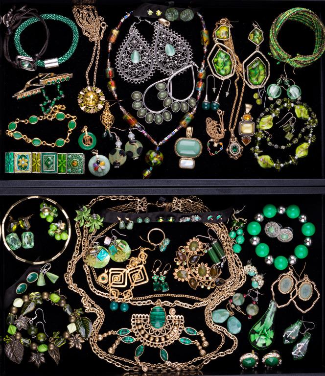 Green Costume Jewelry (2 Trays): Two trays with 58 items featuring vintage Avon necklaces; a vintage glass bead and rhinestone sweater clip; and glass and stone bracelets, pendants, earrings, and necklaces.