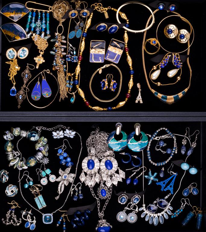 Blue Costume Jewelry (2 Trays): Two trays with 60 items featuring a pair of Weiss screwback earrings with pronged rhinestones, 2 pair of gold tone Trifari earrings with blue center cabochons, a Napier 4mm gold tone bangle with blue