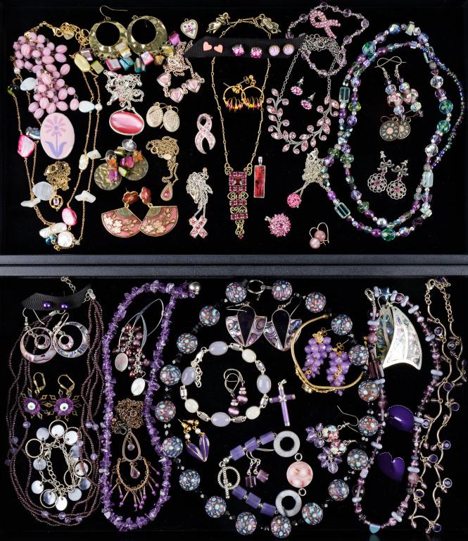 Sterling, Purple, and Pink Costume Jewelry: Two trays with 54 items featuring a 15" Mary DeMarco pronged pink rhinestone necklace, a Nakamol double strand necklace, a sterling silver bracelet with lavender and ivory stone cabochons, three pair 