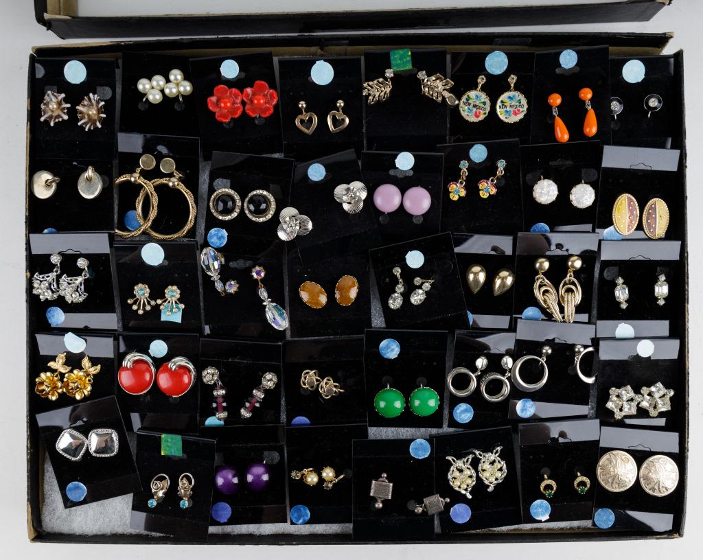 Forty Pairs of Vintage Earrings: Lot includes forty pairs of various vintage earrings in gold and silver tone, plastics, rhinestones and other. Includes a snow case mount.
