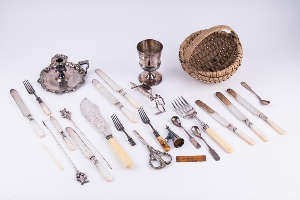 Vintage and Antique Silver Plate and Sterling: Mother of pearl and sterling band knives, Sheffield England serving set with bone handles, an early candlestick and Pai point cup. Sterling handled grape scissors and much more including a vintage bas