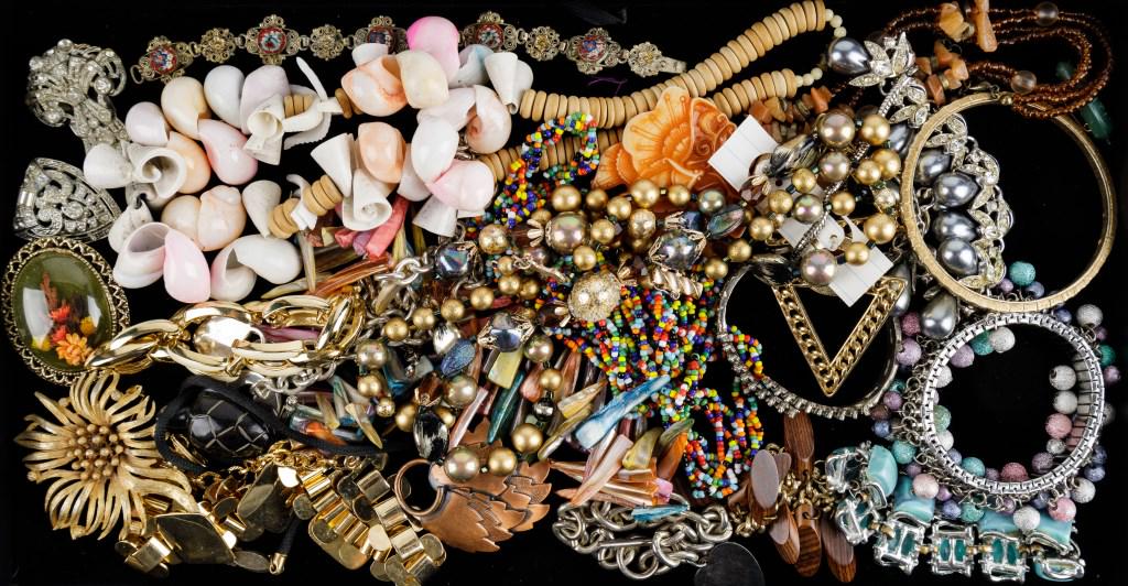 Gold Tone and Colorful Costume Jewelry: Necklaces, bracelets, earrings, brooches, fur clips. Necklaces with colorful shells, small beads, large beads, a turtle pendant, and a mod style gold tone. A Tiffany-style heart necklace and bracelet.
