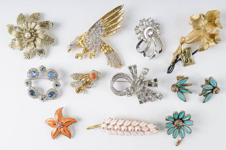 Estate Vintage Brooch Collection: "Ceil Chapman" clear rhinestone floral brooch, several "Trifari" including blue "Trifari" daisy brooch and matching earrings and more. "Eisenberg" large eagle brooch, "Ciner" circle brooch, "Coro" bro