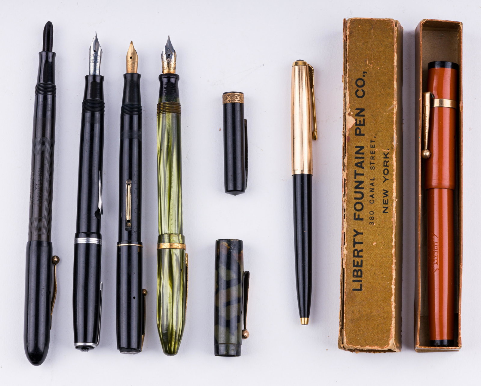 Vintage Writing Utensils: Lot of six vintage items consists of five fountain pens and one pencil. Fountain pens include names Liberty, Waterman, Ideal and Esterbrook. There are also two additional caps. Liberty fountain pen co