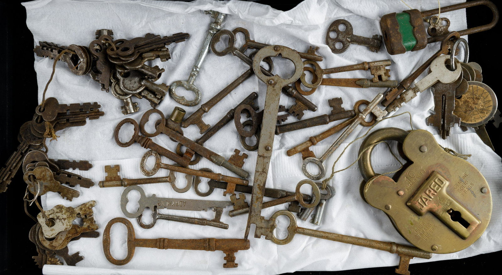 Antique and Vintage Keys & Locks: Most of the lot consists of vintage and antique skeleton keys with some other items including two locks (both with keys, brass lock marked Jared). All keys have oxidation. See photos.