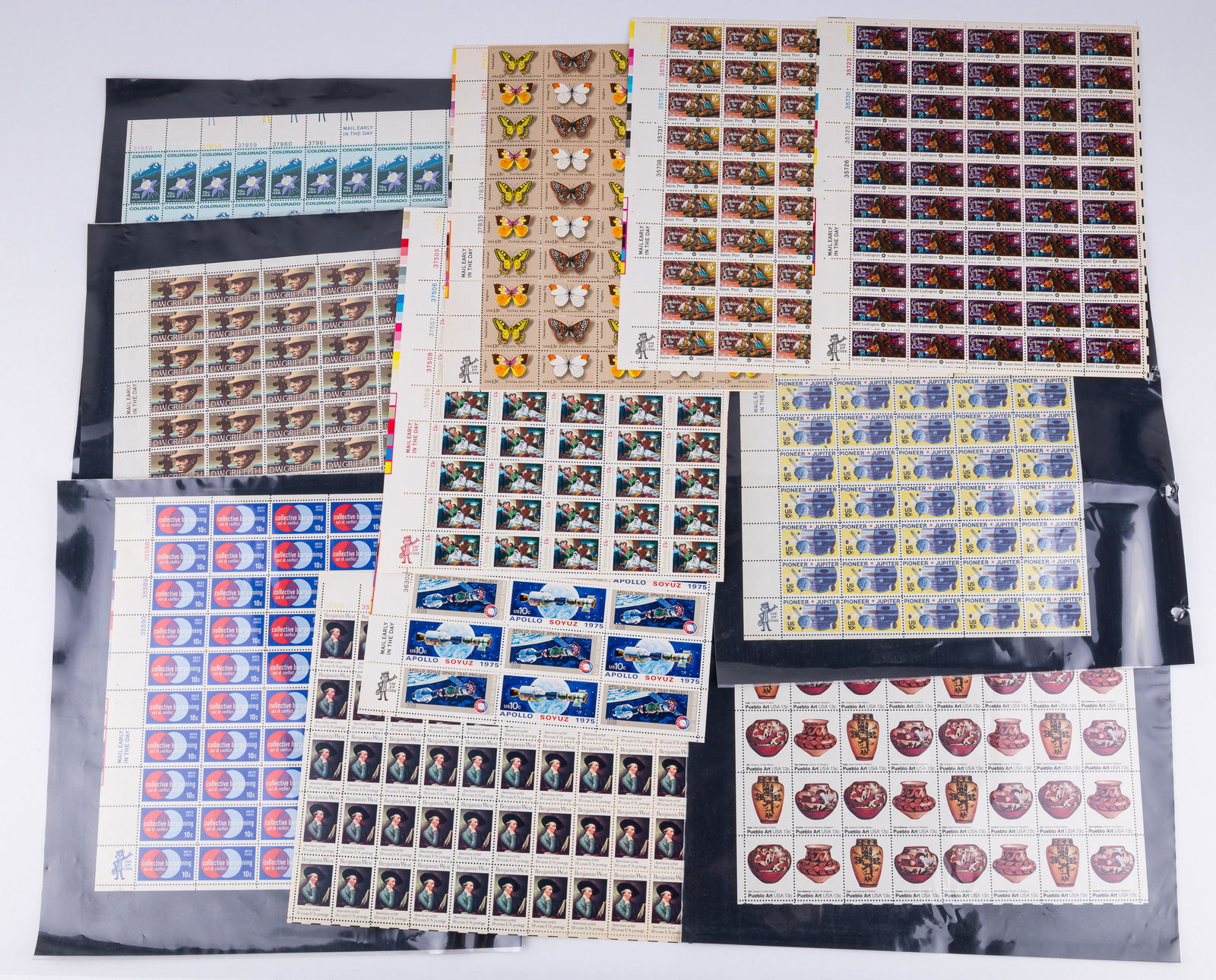 United States Collectible Postage Stamps: Lot includes full sheets of postage stamps including Sybil Ludington, DW Griffith, Colorado, butterflies, Pueblo art, Christmas, Pioneer Jupiter, Collective Bargaining, Apollo Soyuz and Benjamin West.