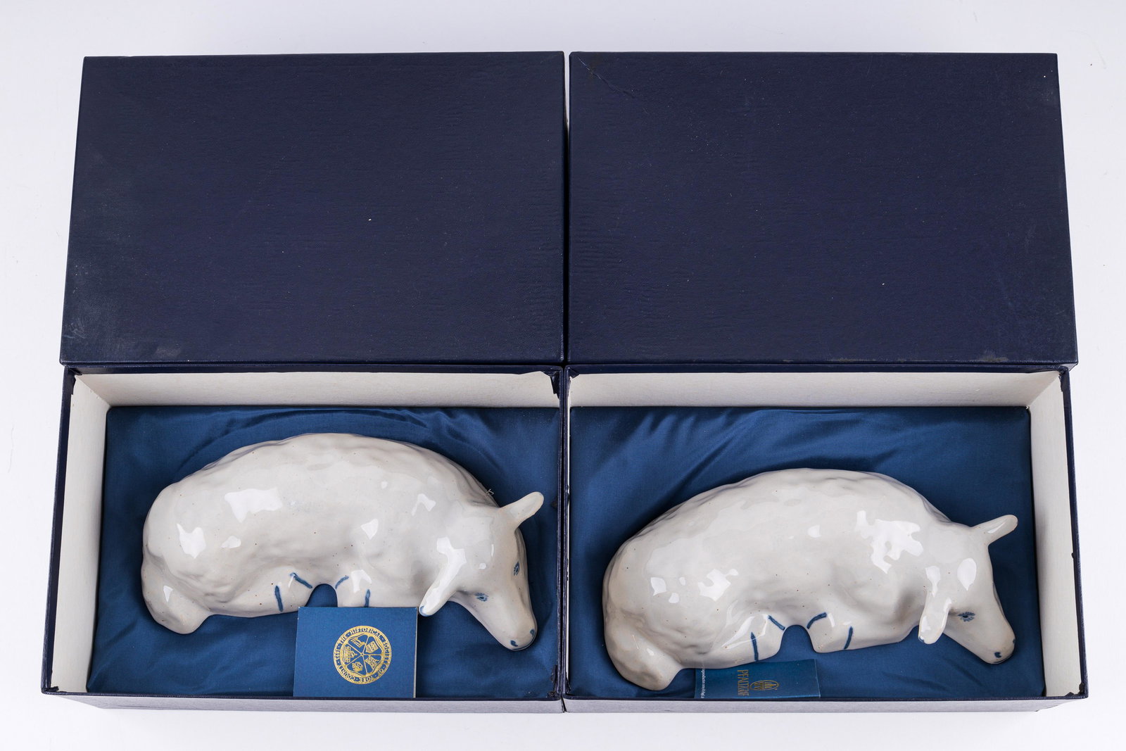 Pfaltzgraff York Historical Society Lamb Figurines: Lot of two Pfaltzgraff reclining lambs for the York Historical Society. Each is individually numbered (160 and 184). These are a 1989 limited editions of 200 reproduction from the 1925 original. Mint