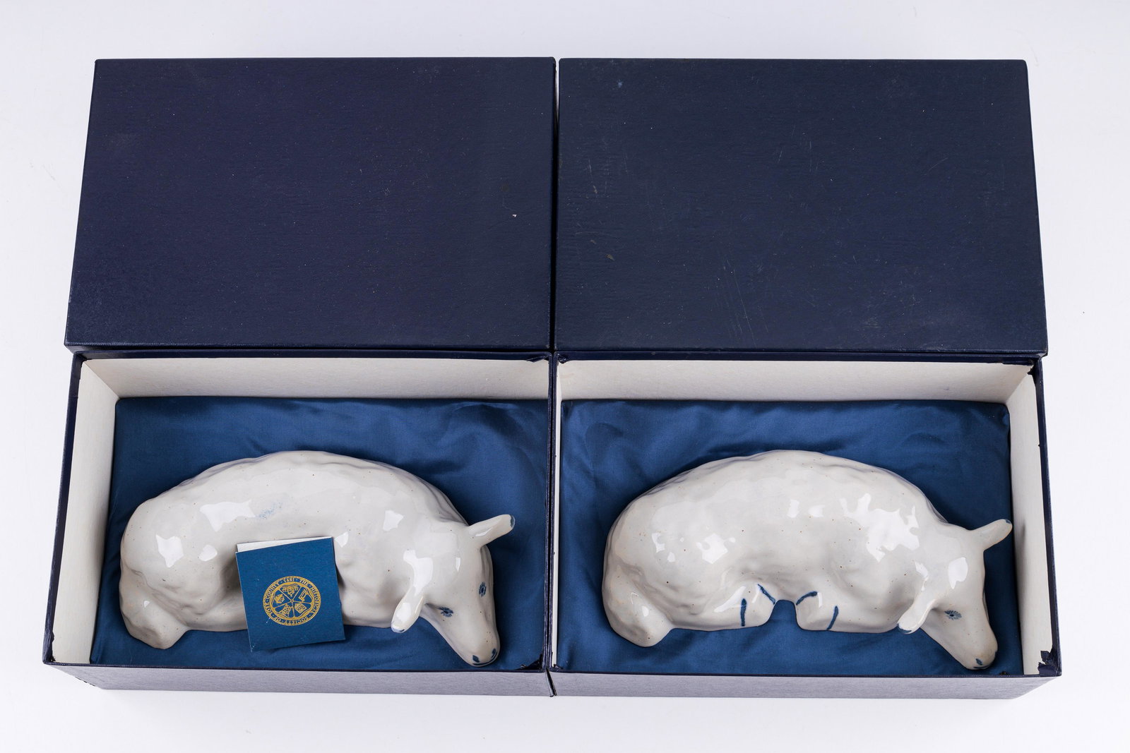 Pfaltzgraff York Historical Society Lamb Figurines: Lot of two Pfaltzgraff reclining lambs for the York Historical Society. Each is individually numbered (163 and 162). These are a 1989 limited editions of 200 reproduction from the 1925 original. Mint