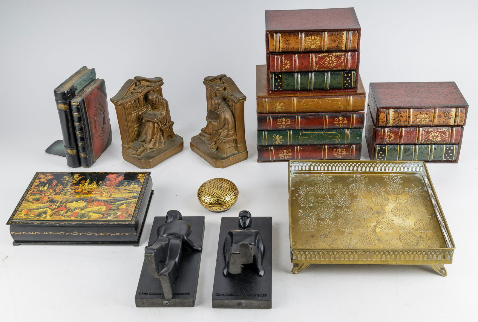 Chris Collicott Bookends, Russian Boxes & More: Lot includes a pair of Chris Collicott for Kikkerland Art Deco style pushing man bookends, copper layers scholar bookends and three book boxes. There are also two Russian Lacquer boxes (one smaller) a