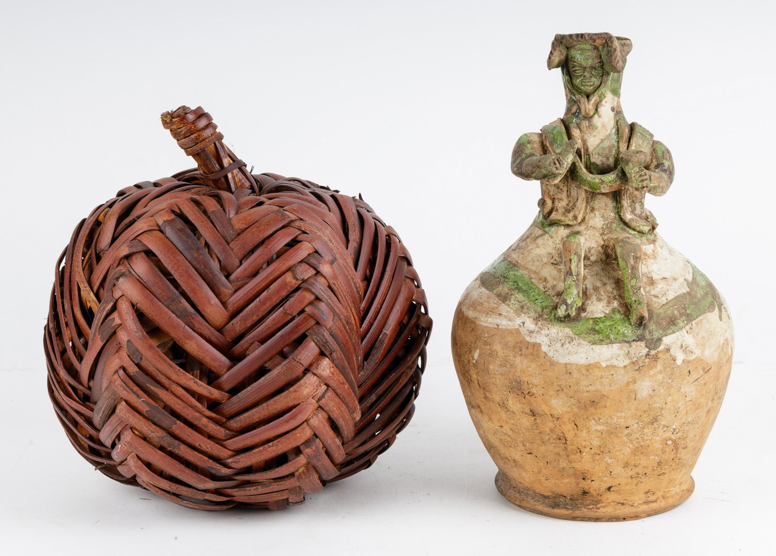 Effigy Pot & Wicker Pumpkin: Pre-Columbian style terracotta effigy pot and wicker pumpkin. Effigy pot approx 11.5" H and wicker pumpkin approx 9.5" H. Good condition.