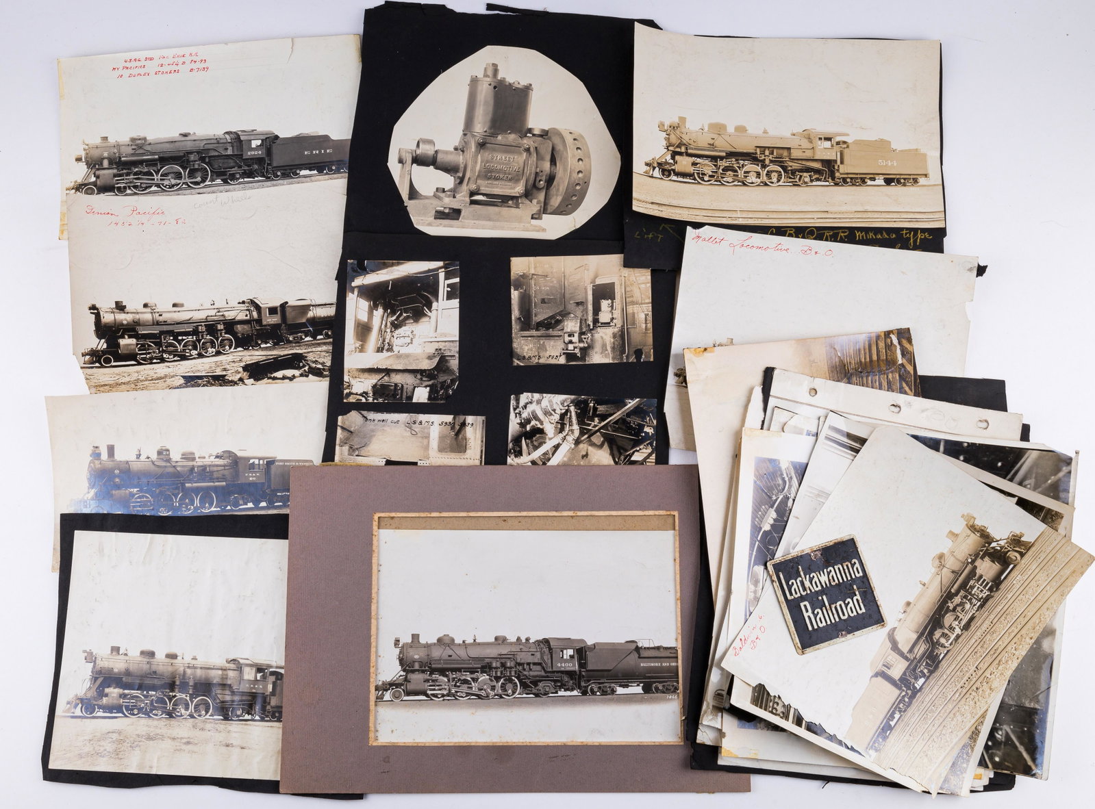 Vintage Railroad Photographs: Lot of 20+ various black and white photos of trains including steam engines and parts. Some are mounted on paper. There is a small Lackawana Railroad sign. See photos.