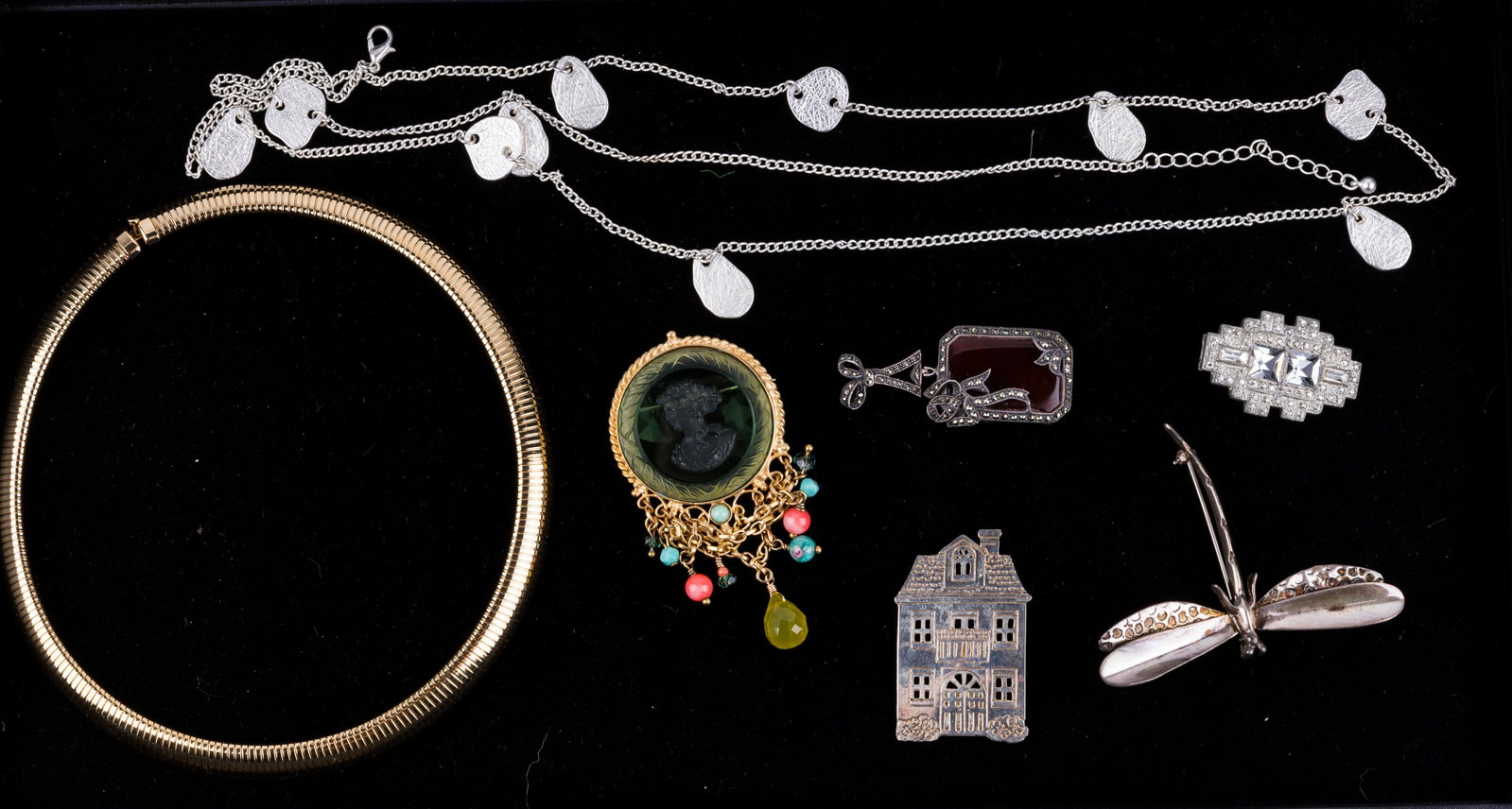 Sterling Silver & Costume Jewelry: Lot of seven pieces of jewelry including three pieces that are sterling silver including two brooches (a house and life size dragonfly) and a framed stone with marcasite pendant. There is also a, Exta