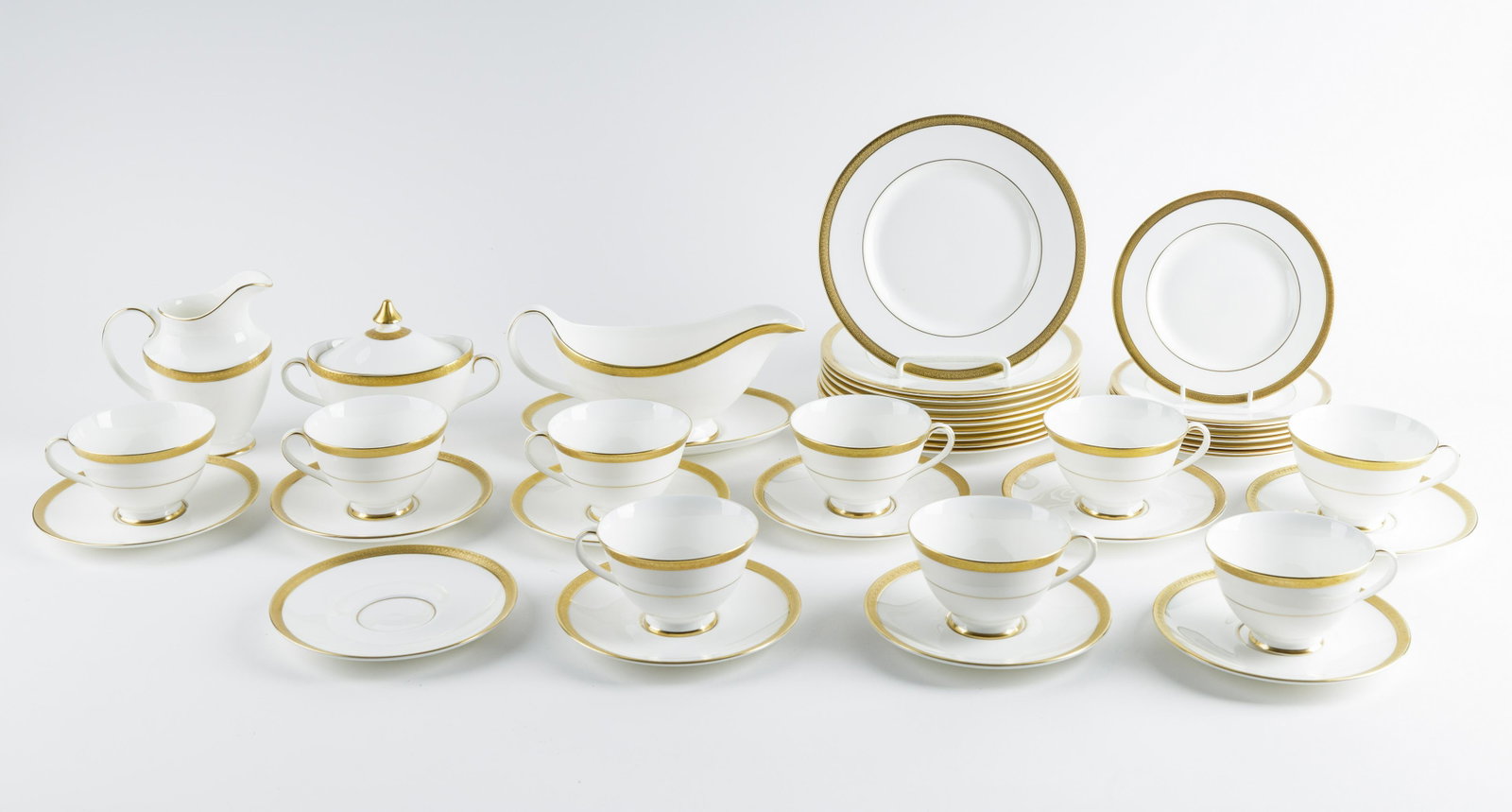 Royal Doulton Partial Dinner Service: Royal Doulton partial dinner Service includes covered sugar, ten saucers, nine cups, a gravy boat with undertray, creamer, eight 6.5 " plates, ten 8" plates bottom of plates read "Royal Gold "