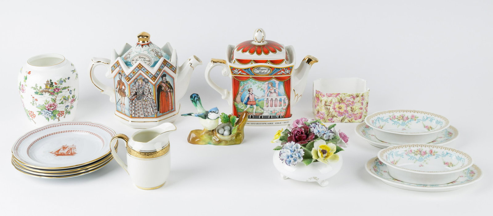 English Porcelain Group: English porcelain includes two Sadler, one Elizabeth the 1st and the other Romeo and Juliet. Crown Victorian tea bag holder. Four Spode trade wind measuring approx 6" H. Royal Doulton porcelain basket