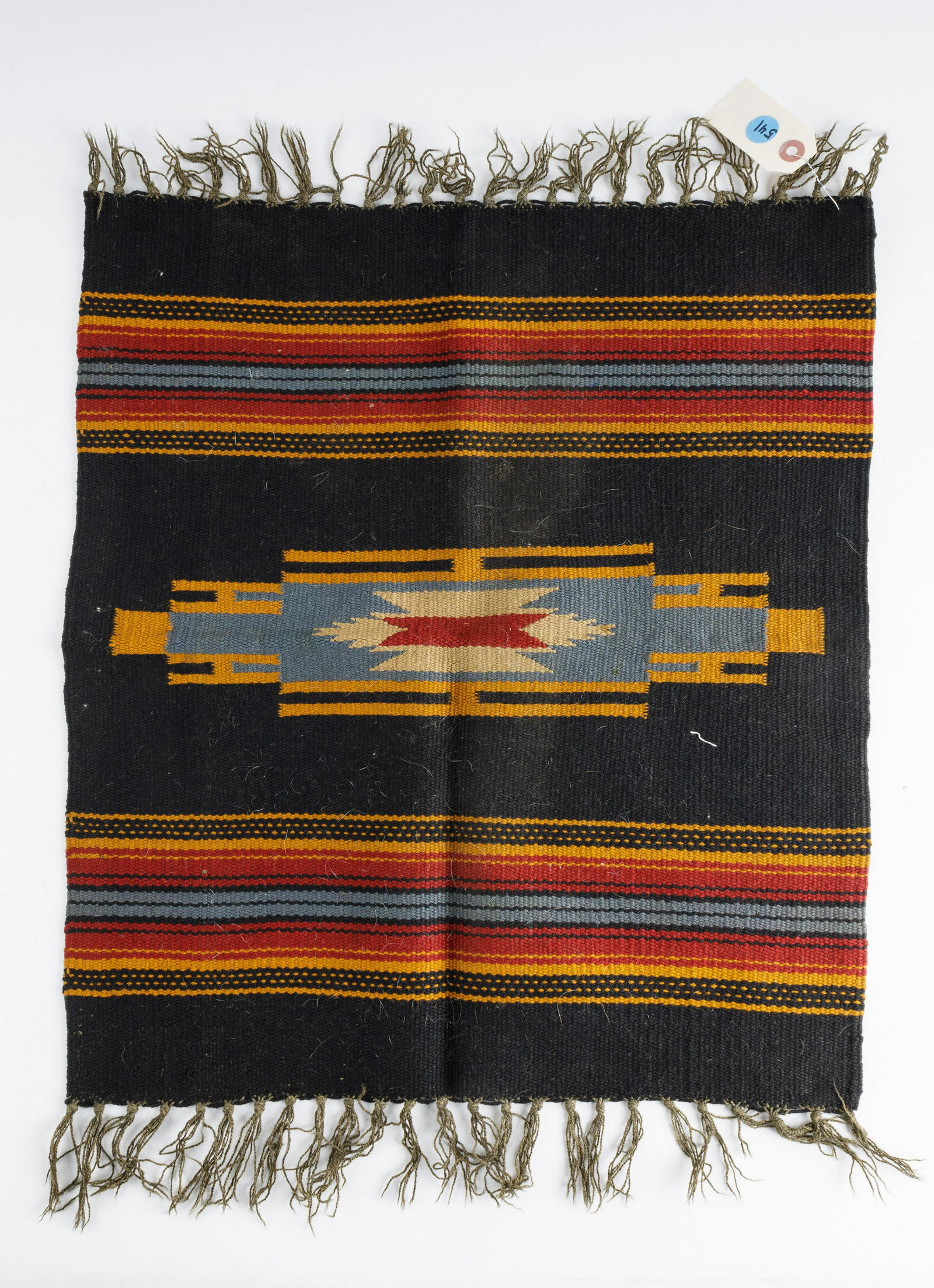 Native American Antique Hand Woven Rug: Small, somewhat square hand woven rug likely woven in the early 20th century. Patterns are indicative of Native American origin. Rug measures approx 18" x 21".