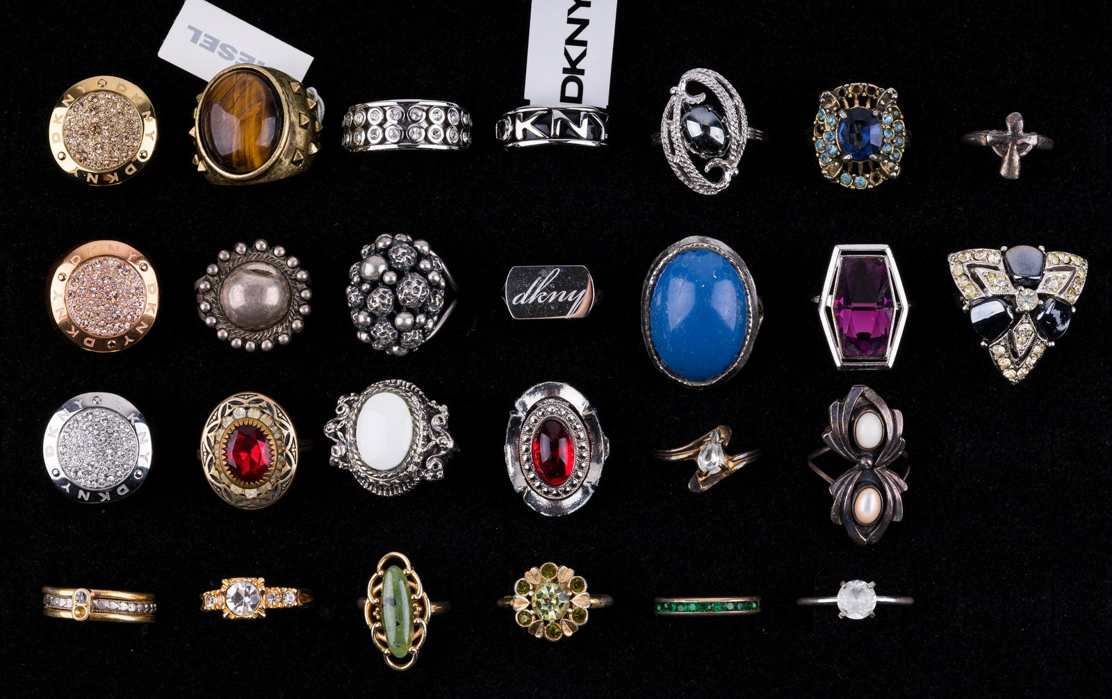 Cocktail Rings: Lot of 26 cocktail rings include 6 DKNY, a Diesel and more. Various sizes and conditions.