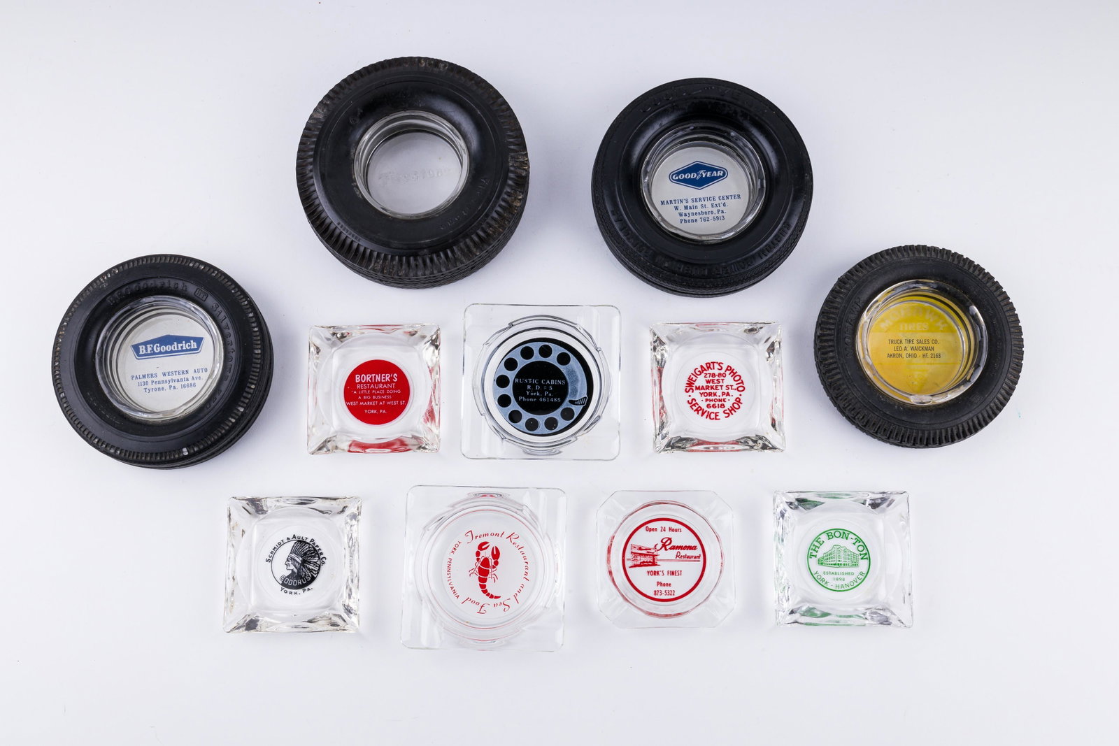 Early York Pennsylvania Advertising Ash Trays: Lot of advertising York, Pennsylvania ash trays including names such as The Bon Ton, Tremont, Swegarts Photo, Ramona, Bortner's as well as four rubber tire advertising from various locations, some out