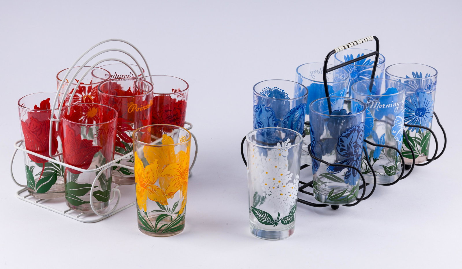 Vintage Peanut Butter Glass Sets: Lot of 14 peanut butter glasses including a set of blue flowers and a set of red flowers with carriers, in addition to two other glasses. Good condition.
