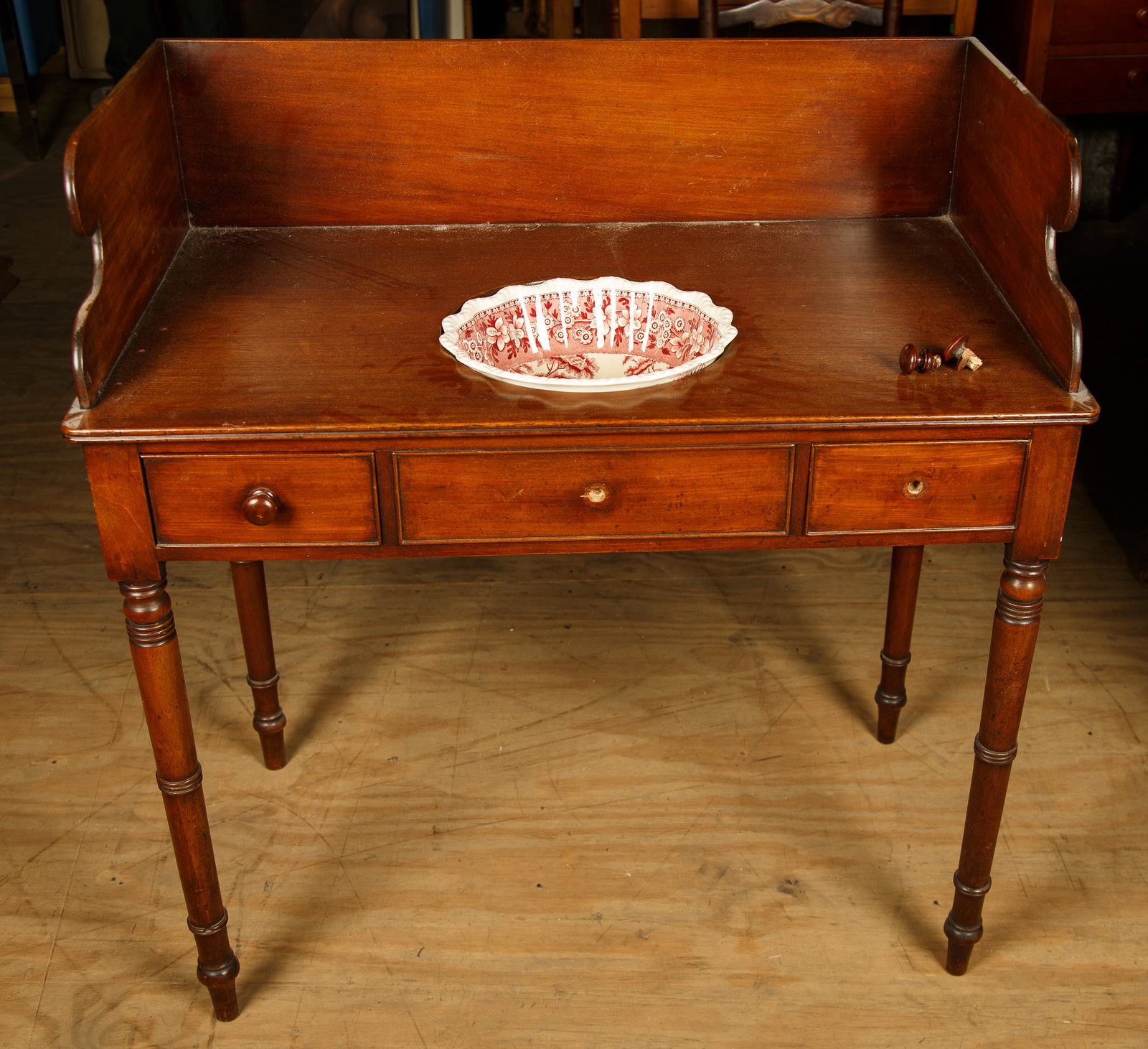 English Mahogany Washstand w/ Spode Bowl: Washstand has a backsplash and is period Sheraton, Bowl is 11 1/2" in diameter and was added later. Stand measures 38" H at backsplash x 20" D x 36" and right drawer pull is in drawer.Furniture Pick-u