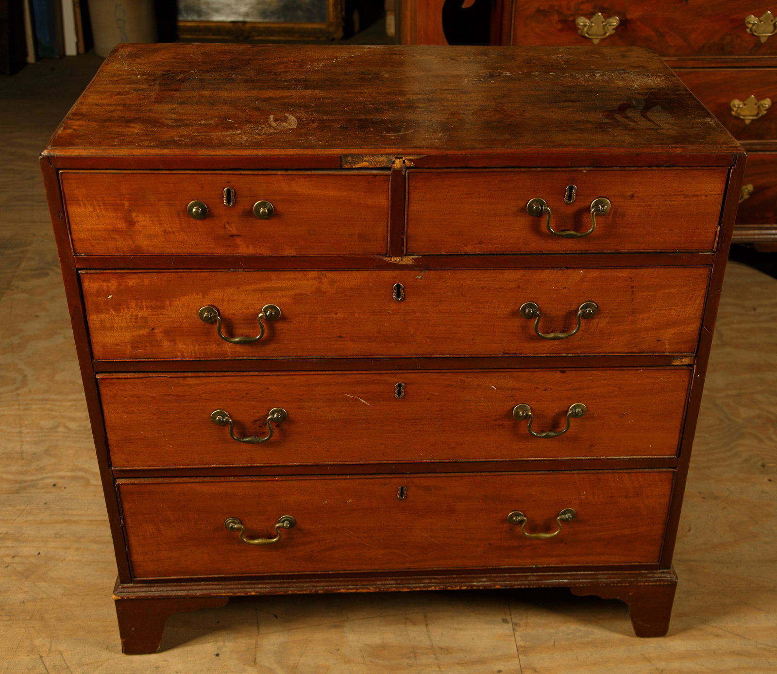 Chippendale Chest of Drawers, Period English: Chippendale mahogany chest of drawers is a period piece, measuring approx 35" H x 19" D x 35 1/2" W. It has original bail pulls. There is some damage in two sections around center top drawer and missi