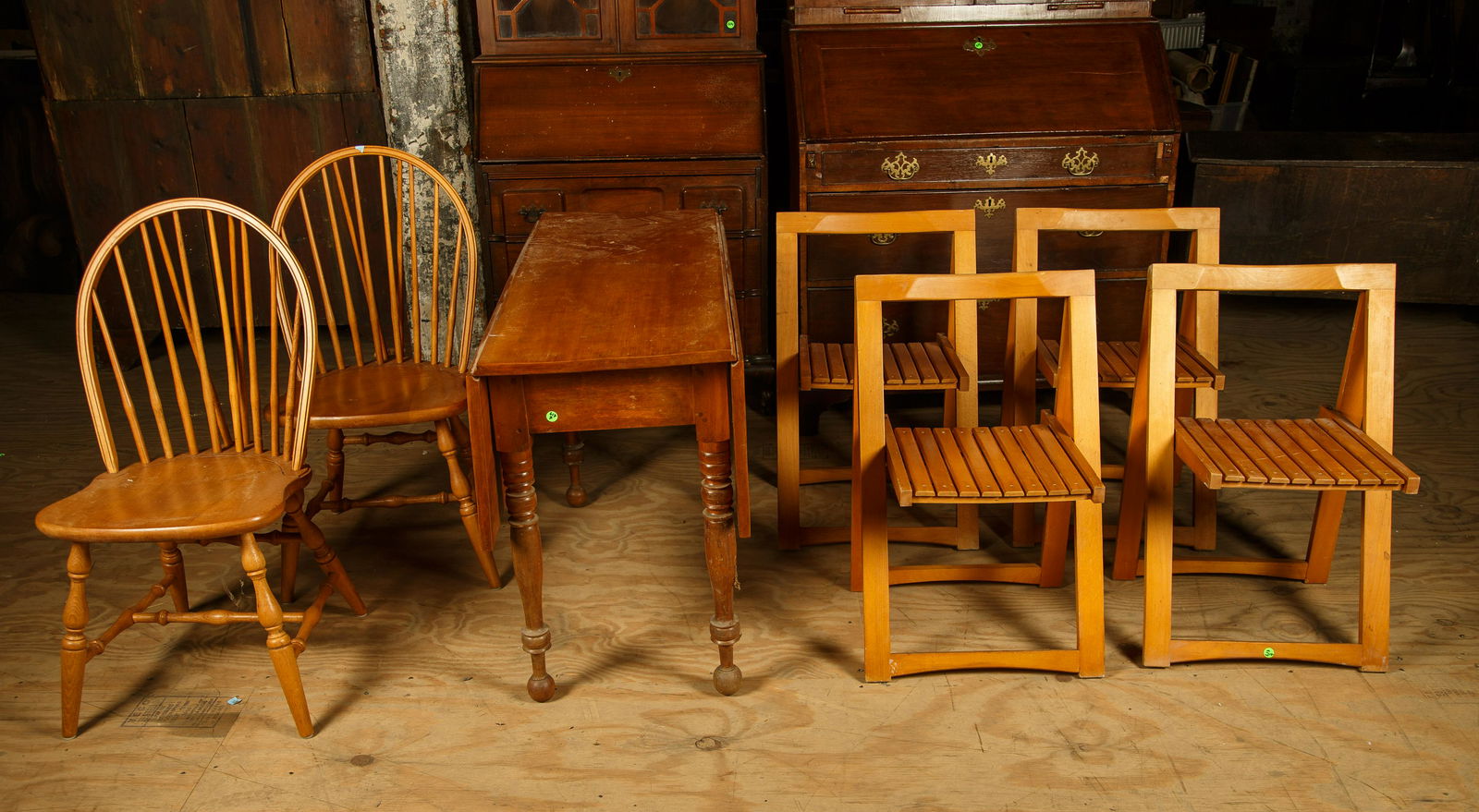Mid 19th C Maple Drop leaf Table & Chairs: Maple table measures 28 1/2" H x 42" L x 18" D (closed) and 41" (open). Lot also includes four maple folding chairs and two maple reproduction brace back Windsor chairs. Furniture Pick-up Availability