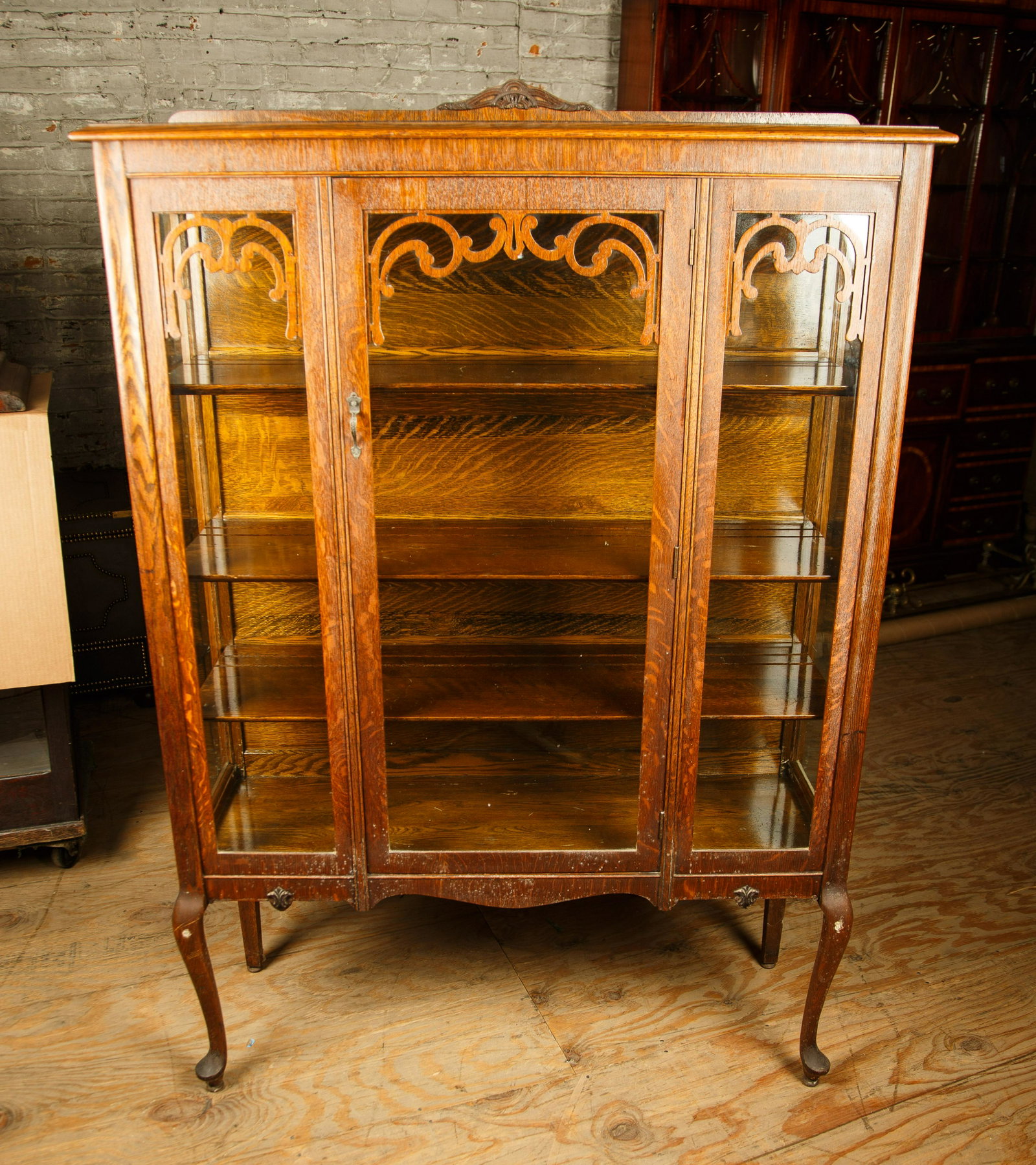 Late 19th C Golden Oak Curio Cabinet: Cabinet measures approx. 63 1/2" H x 44" W x 15 1/2" D and has three shelves. Furniture Pick-up Availability-We will have staff available at our Hay Street Location on Thursday the 20th and Friday the