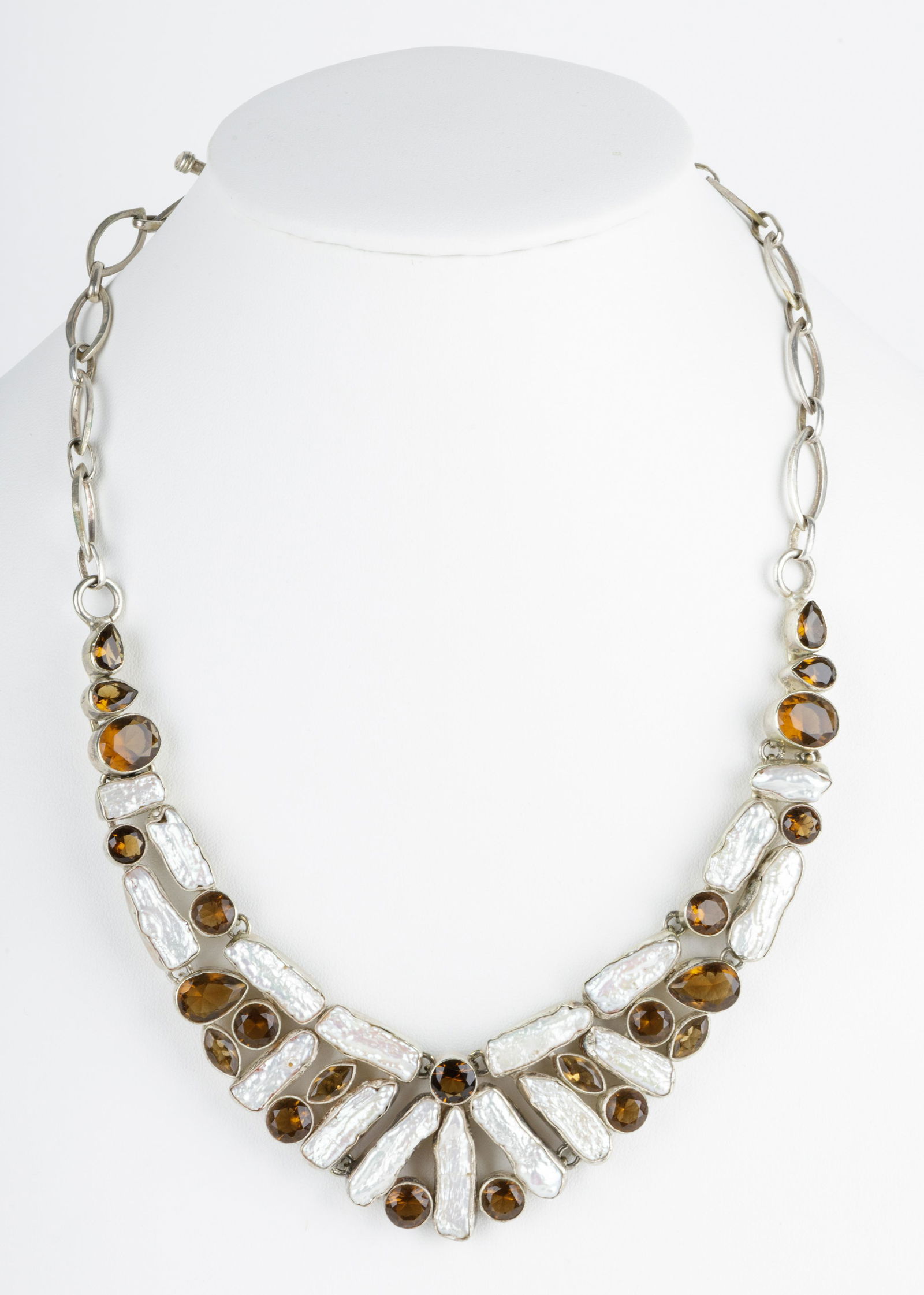 Sterling Silver & Baroque Pearl Bib Necklace: This is is a one of a kind Baroque pearl bib style necklace with brown topaz colored glass accents in a sterling 925 setting. The necklace has an approx 10.5" and approximately 1.5" at the widest poin