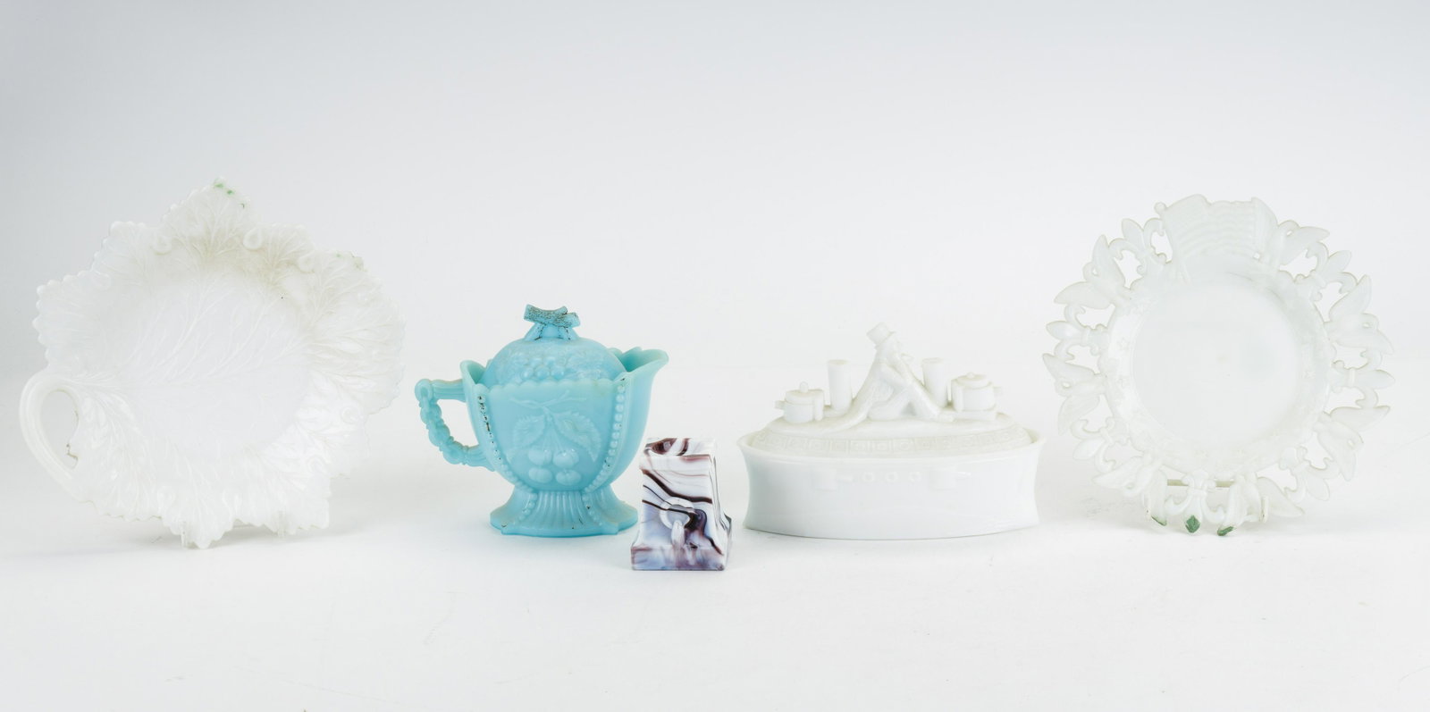 Milk Glass, Slag Glass & Other Glassware: Three pieces of milk glass including one steam boat, leaf dish and plate with pierced border (approx 7.25" dia). There is a slag glass salt and a blue glass covered creamer.