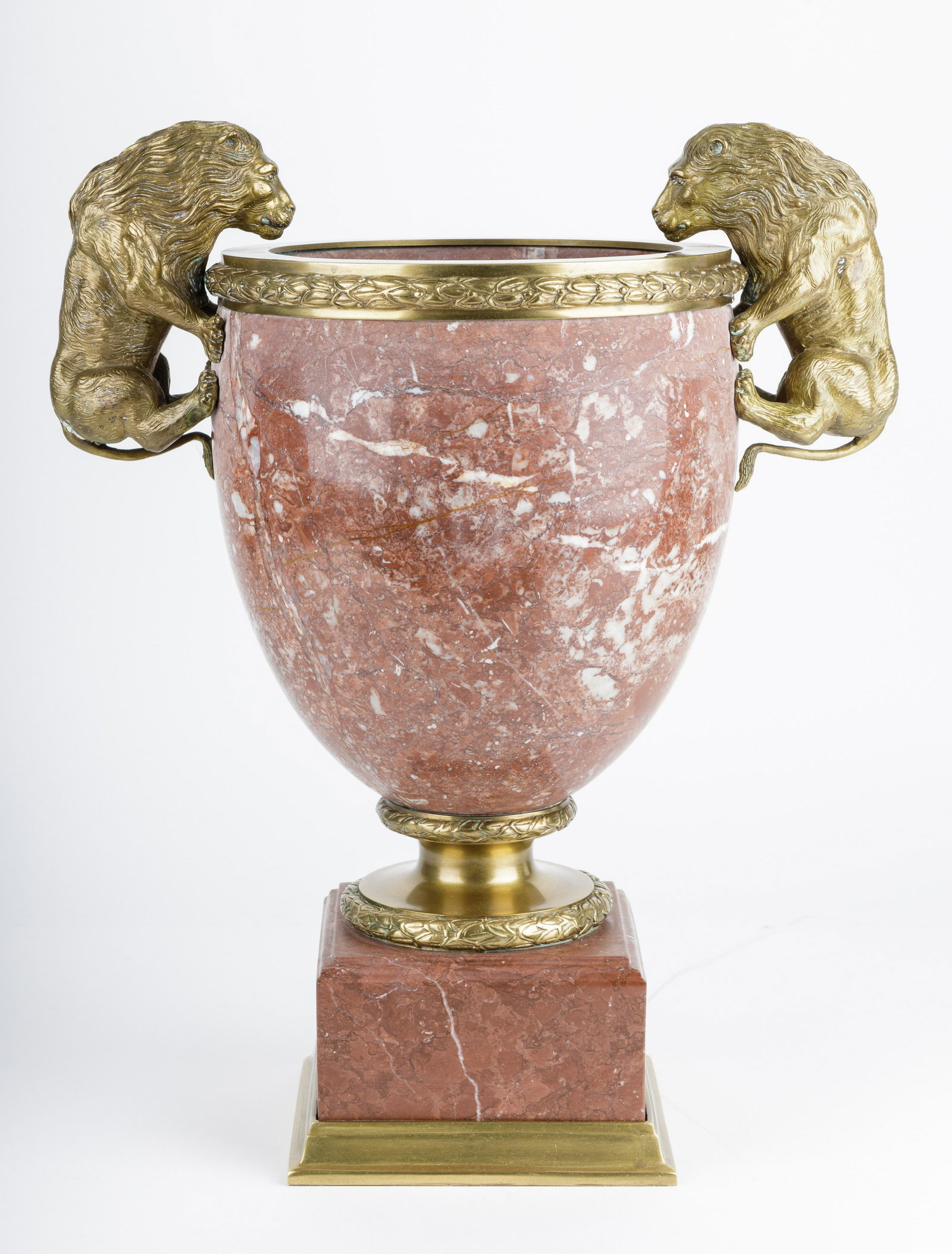 Marble & Brass Lion Handled Urn: Substantial red brown marble urn with brass lion handles measuring approx 17.5" H x 14" W x 9.5" D. Urn weighs approx 37lbs. Good condition. Weight should be considered for shipping.