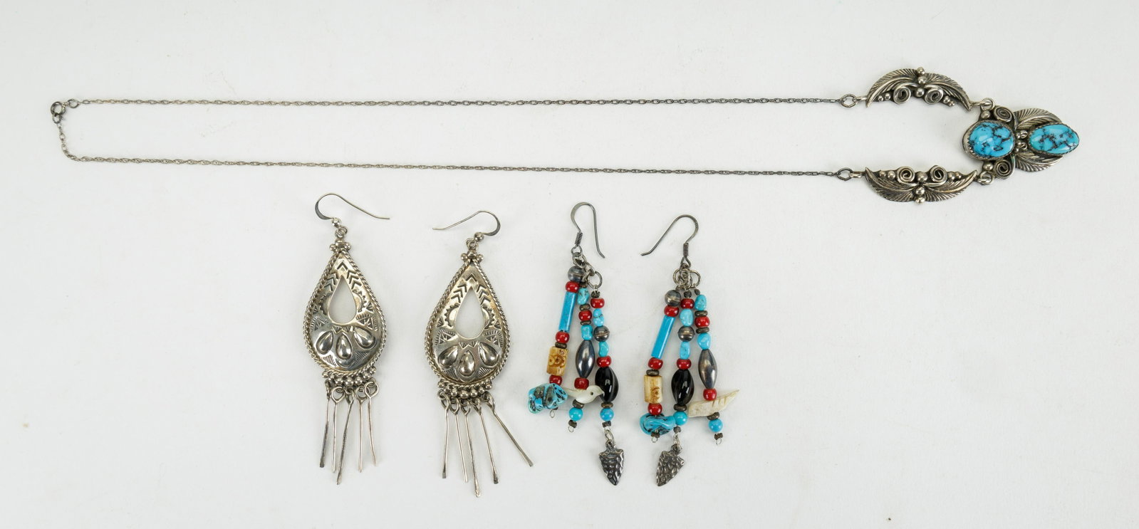 Vintage Sterling Silver Native American Jewelry: Lot includes Native American jewelry including two pairs of earrings and a necklace. Necklace measures approx 20"L with central sterling and turquoise pendant (approx 1.5"L). Long sterling silver earr