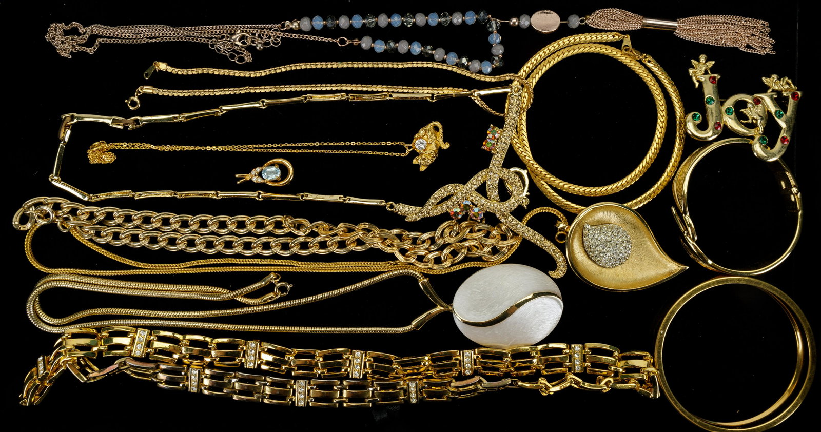 Vintage Costume Jewelry: Vintage gold tone costume jewelry includes necklaces, bracelets, pendant, brooch and more. The longest necklace measures approx 32" L. Highlights include pendant with central blue turquoise, Monet ban