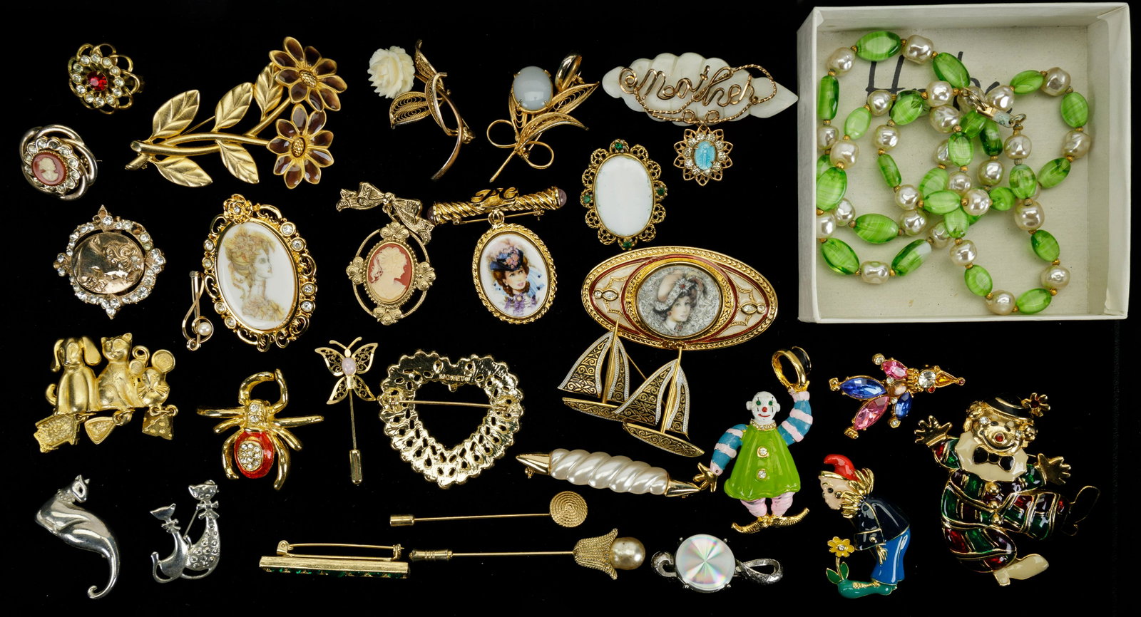 Vintage Costume Jewelry Brooches: Lot includes a variety of gold and silver tone brooches with names including Monet, Avon, Michelieu. There is a damascene ship brooch marked Spain. There is also a freshwater pearl and green glass nec