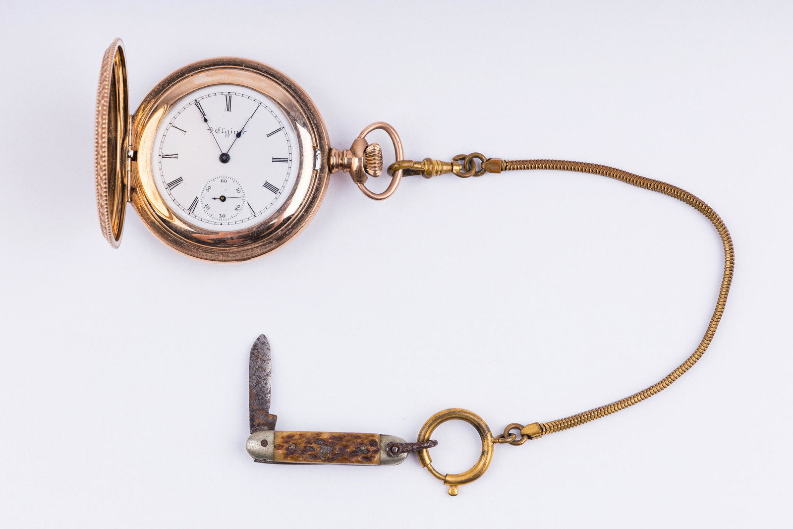 Antique Elgin Pocket Watch: Elgin pocket watch on watch chain with stag bone Scout pen knife (Wadsworth Germany) and a watch fob. Watch has case #608607 (Wadsworth guarantee 20yr) and watch #8329659 seven jewels. Watch runs but
