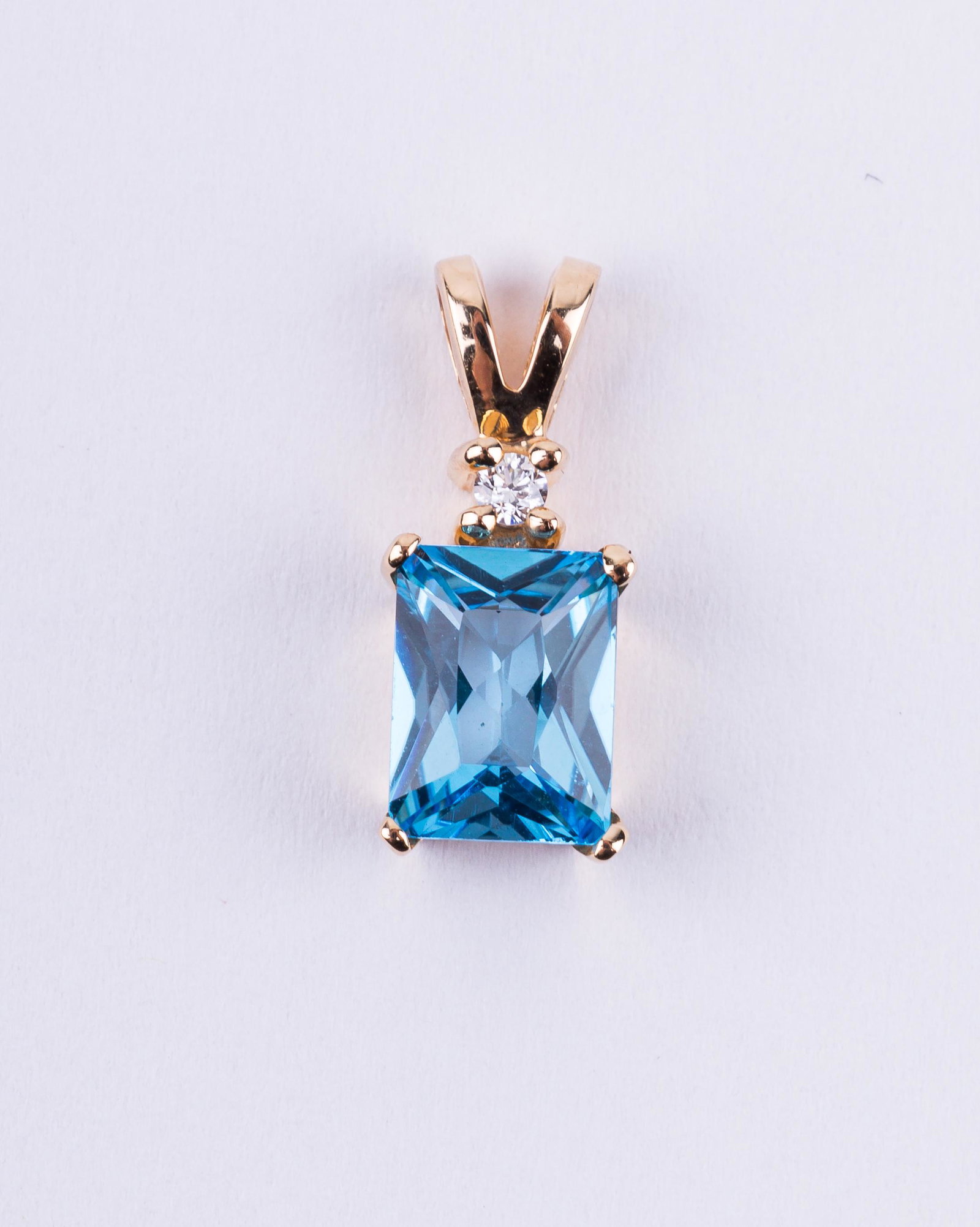 14K Gold Tanzanite & Diamond Pendant: 14K yellow gold tanzanite and diamond pendant has a drop of approx 5/8" L and weighs approx 1.5g. The tanzanite stone is approx 1/2ctw.