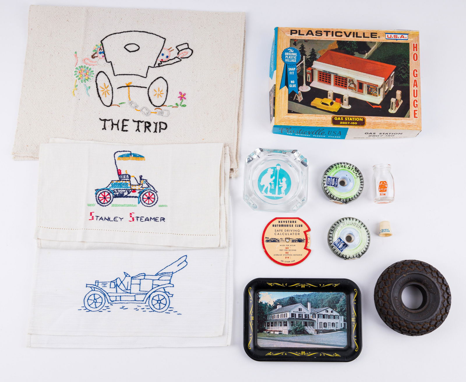 Lincoln Hwy and Transportation Collectibles: Mini Liberty Milk jug, a Plasticville gas station, early Howard Johsnon logo ash tray, Keystone Auto Club safe driving calculator, a Hershey Filling Stat ion plastic thimble, a Firestone rubber tire 4