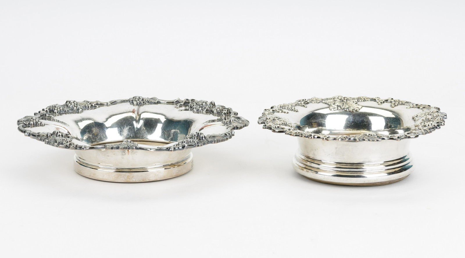 Victorian Wine Bottle Coasters: One Sheffield Silver on Copper coaster, marked 29.9, 9.75 inches diam, one silver coaster 8 inches diam.