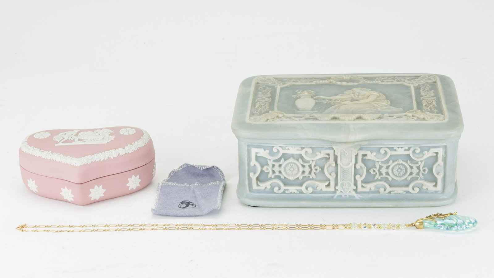 Fenton Necklace, Wedgwood & Incolay Boxes: Lot of three items includes blue Incolay stone jewelry box (approx 3.25" H x 8.5" L x 7" W), Wedgwood pink heart shaped trinket box and Fenton opalescent blue pendant on gold tone necklace (necklace a
