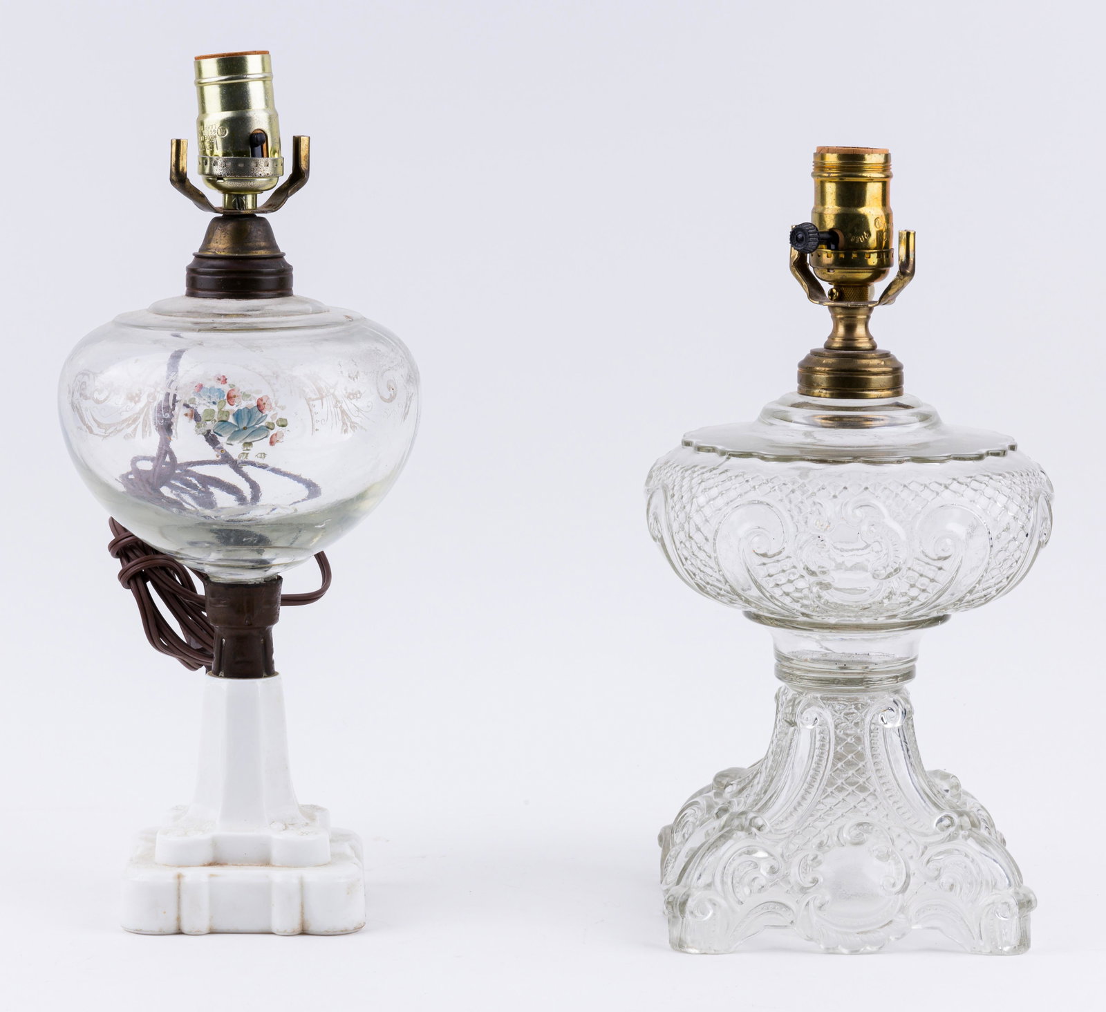 Oil Lamps (2): Lot of two oil lamps with glass fonts, one with a white glass bask. The tallest lamp is approx 17" H.