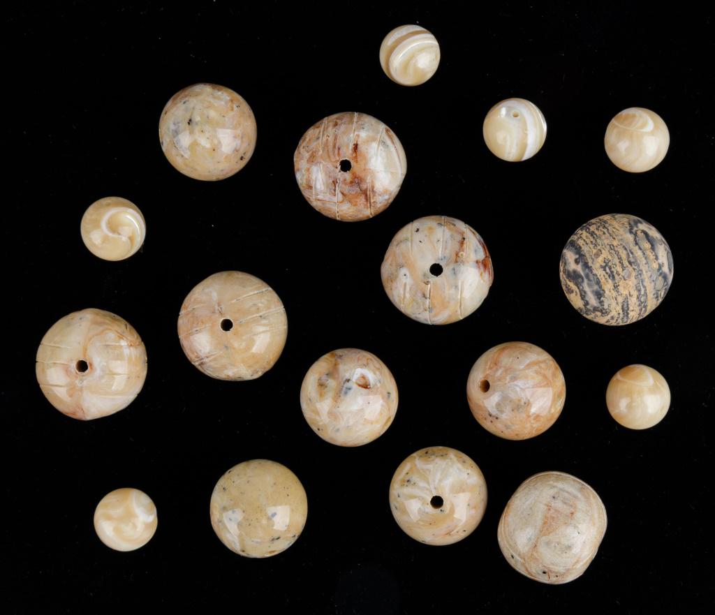 Stephen Dweck Natural Stone Beads: Lot of 15+ Stephen Dweck natural stone beads of various sizes and some are carved. The largest measures approx 3/4" dia. Weight approx 78g.