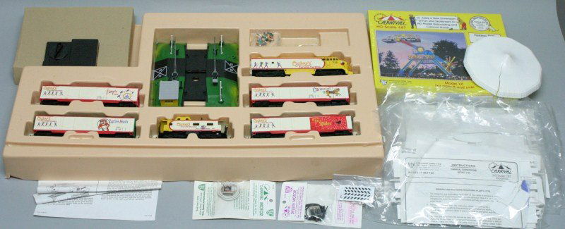 Corkey’s Carnival Caravan Train Set: Includes engine; 4 cars; caboose; controller; plastic kits; carnival motor; falling star model kit
